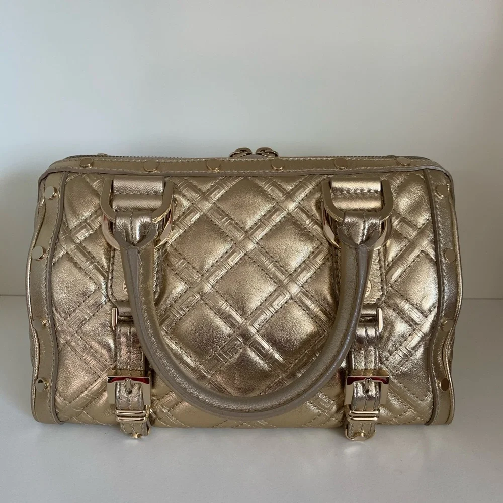 Hold Versace gold quilted handbag